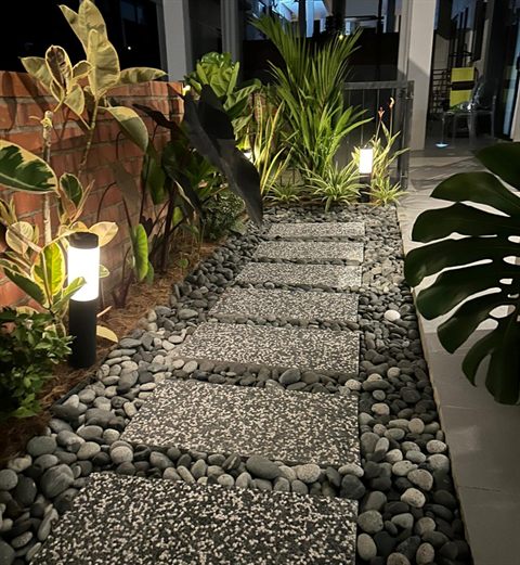 Lit side garden pebble path night — Landscape Build by Tanaman Garden Co.